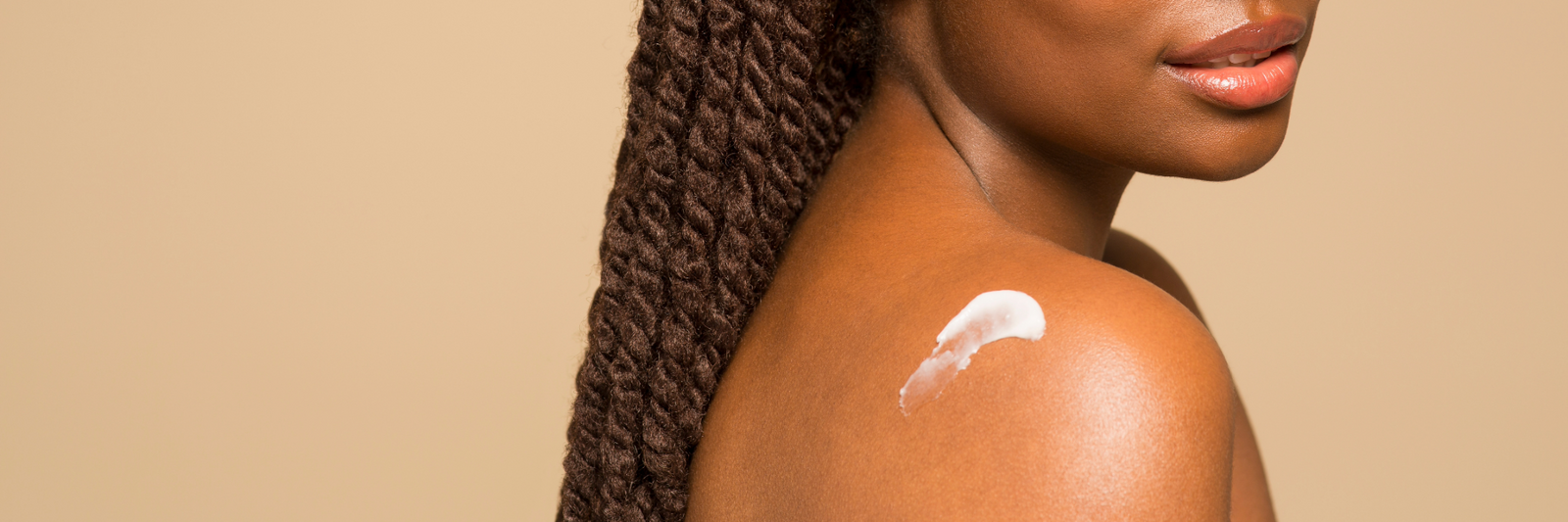 woman with skincare applied to her shoulder | mindful beauty magazine