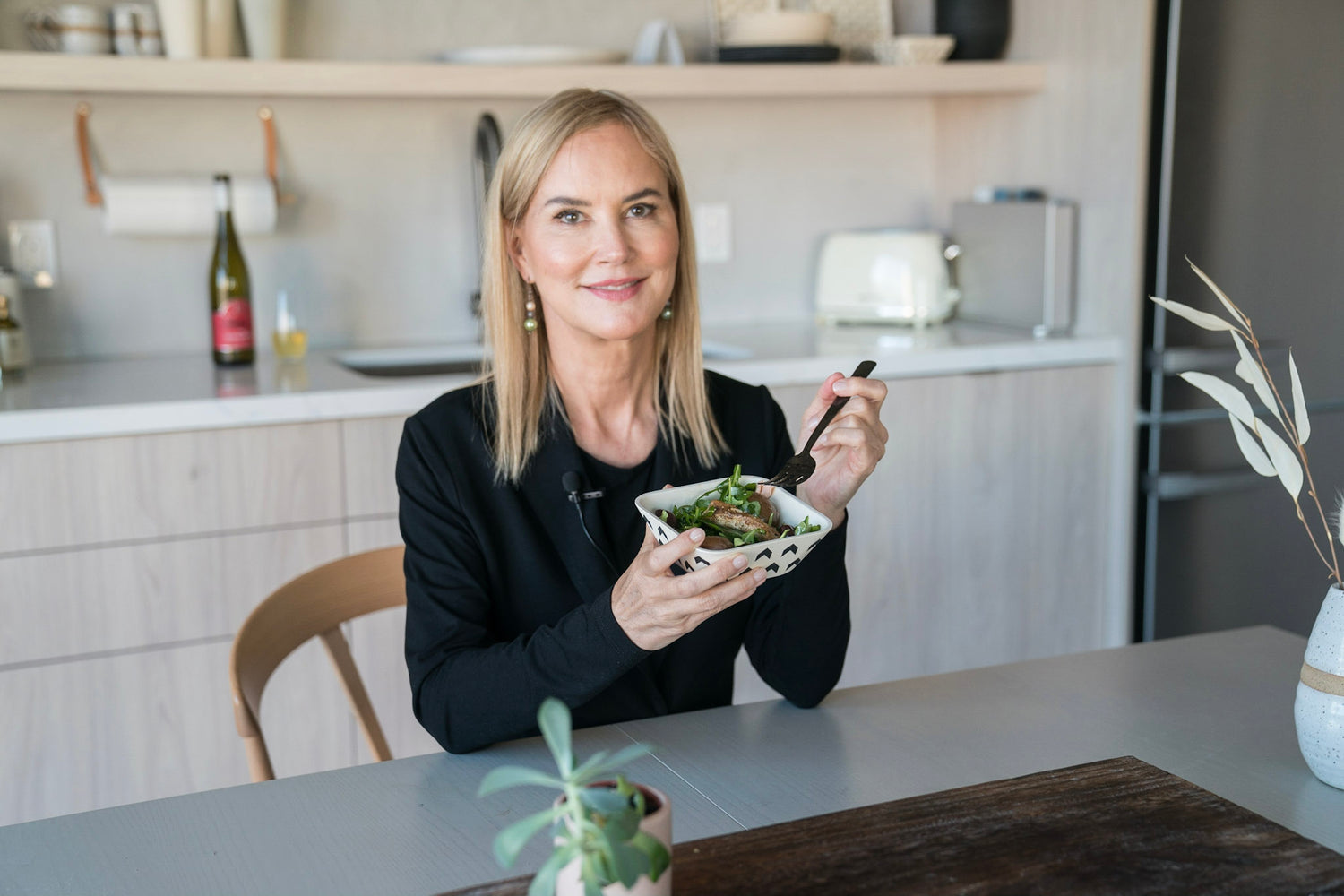 graydon in the kitchen with a bowl of greens